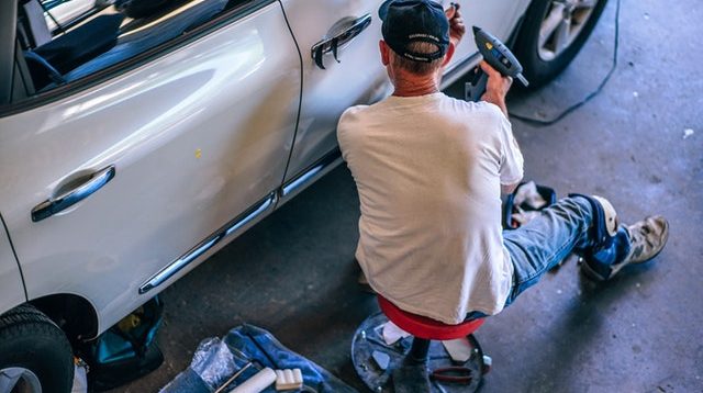 Man working on car in garage